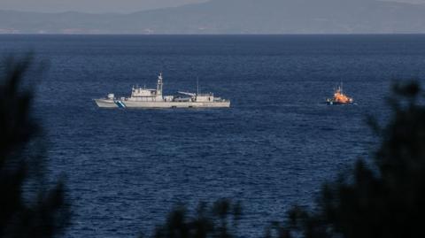 A Greek Coast Guard ship and an escorting vessel take part in a search and rescue operation following a shipwreck, where at least eight migrants drown off the island of Samos, Greece.