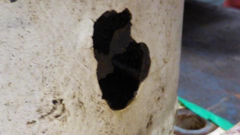 A large hole in pipework aboard a North Sea oil platform