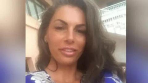 A woman in a blue floral top. 