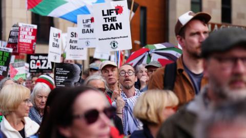 A group of protesters with pro-Palestine placards