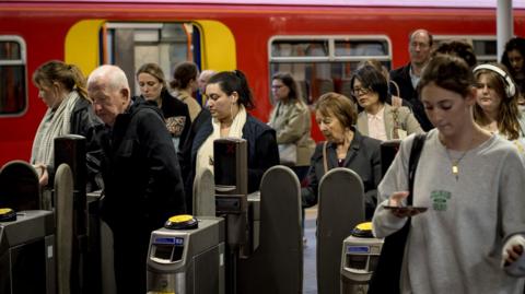 passengers arrive at Guildford station