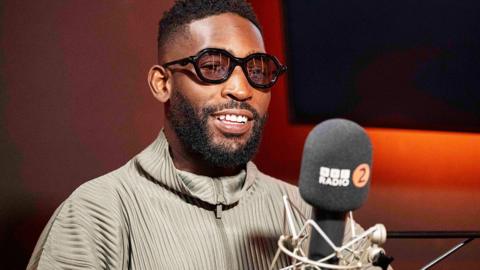 Tinie Tempah talking into a BBC Radio 2 microphone