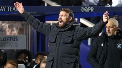 Luton manager Rob Edwards raises his arms in despair