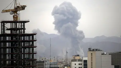 Smoke rises among the residential buildings following an Israeli attack on Tehran, Iran on March 10, 2025