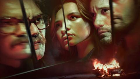 Three faces appear in fragmented reflections under red lighting. A burning car in the corner.