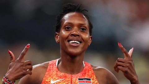 Faith Kipyegon celebrates winning her fourth world 1500m title