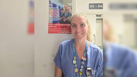 A nurse wears a body-worn camera on her overalls. 