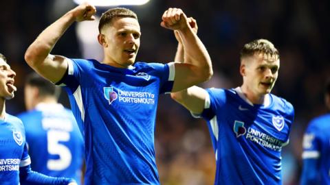 Portsmouth goalscorer Colby Bishop flexes his muscles in celebration