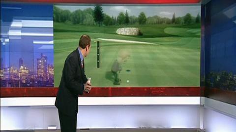 A news reporter plays Wii golf