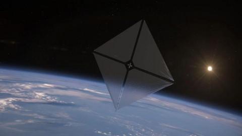 a solar sail spacecraft soaring through space above earth