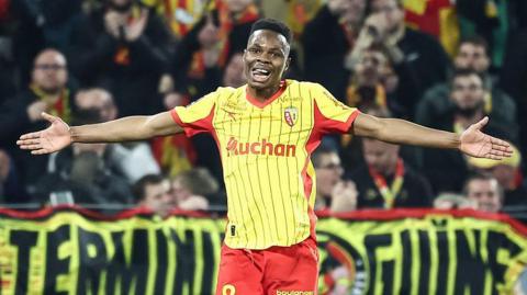 Mamadou Sangare pictured with his arms outstretched while playing for Lens