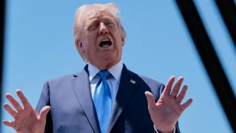 U.S. President Donald Trump speaks to the media before departing Palm Beach International Airport en route to Joint Base Andrews, in West Palm Beach, Florida