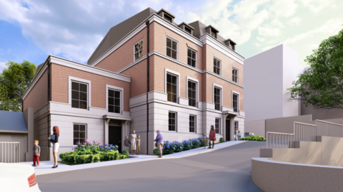 Concept image of what the hotel will look like. It is a four storey building, which is four windows wide. There is also a smaller two storey annex adjoined on the left hand side. Flower beds with colourful blue and pink flowers can be seen with a pavement outside with people walking along. The exterior of the building is stoneclad on the ground floor, and then red brick on the upper floors. A large white building can be seen to the right hand side but has no distinctive details.