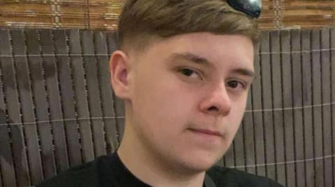 Harvey Willgoose, a teenager in a black T-shirt, looks at the camera