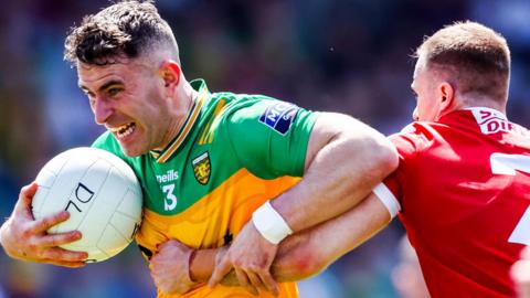 Donegal defender is tackled by Cork's Matty Taylor in Saturday's All-Ireland SFC encounter