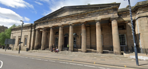 The exterior of Perth Sheriff Court, a large sandstone building with eight columns at the front