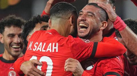 Ramy Rabia of Egypt celebrates with Mohamed Salah