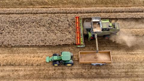 Aerial photo of a combine harvester out on the fields during the summer harvest, near Benfeet on 12 August