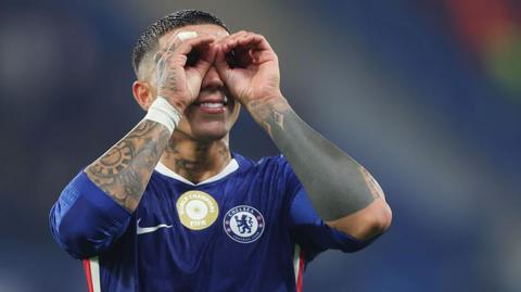 Enzo Fernandez cups hands around eyes celebrating win at end of match