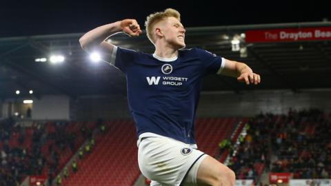 Josh Coburn leaps in the air and celebrates with a fist pump