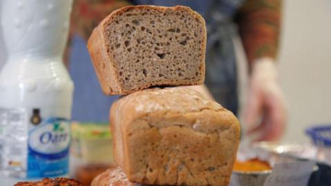 Stock image showing a loaf of bread on top of another.