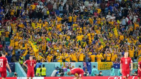 Australia fans celebrate after reaching the last 16 of the 2022 World Cup by beating Denmark in their final group game