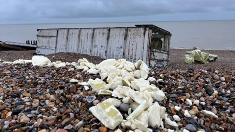 Debris from the containers strewn across the pebble beach in Selsey. It all appears to be packaged up.