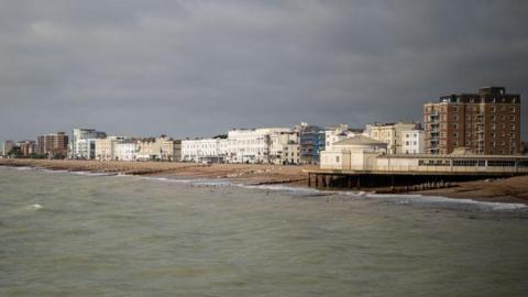 A shot of Worthing seafront. There are grey skies above.