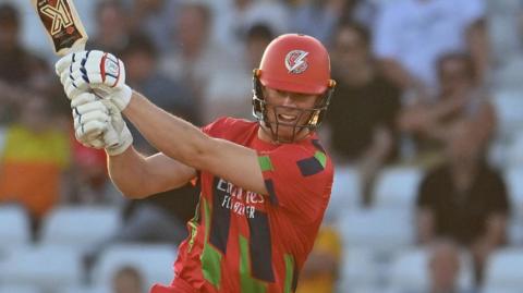 Keaton Jennings batting for Lancashire on a sunny evening in their red T20 kit