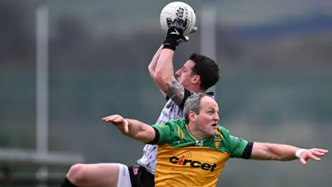 Niall Morgan outfields Michael Murphy in Letterkenny