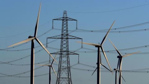 File photo dated 28/12/17 of a view of the Little Cheyne Court Wind Farm amongst existing electricity pylons on the Romney Marsh in Kent.