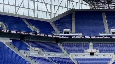 View of a section of blue seats in a football stadium