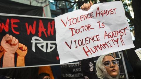 A junior doctor is holding placards protesting inside a government hospital, demanding justice for the victim and safety in hospital premises, and exemplary punishment for those involved in the sexual assault and murder of a woman postgraduate trainee doctor at state-run RG Kar Medical College in Kolkata, India, on August 11, 2024