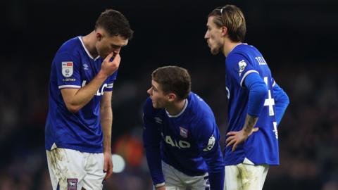 Dara O'Shea talks to his Ipswich Town team-mates Leif Davis and Jack Clarke during their match against Preston North End
