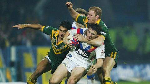 Martin Gleeson is tackled by Michael Crocker of Australia