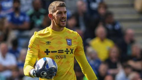 Ipswich Town goalkeeper Alex Palmer holds the ball as he prepares to restart play