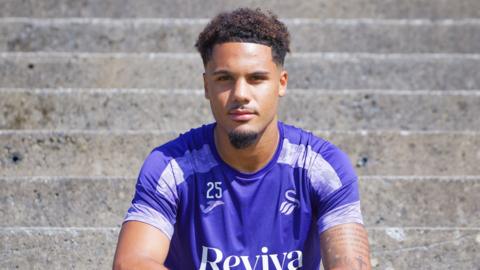 Swansea City's new signing, attacking midfielder Myles Peart-Harris, poses