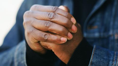 A person cracks their knuckles.