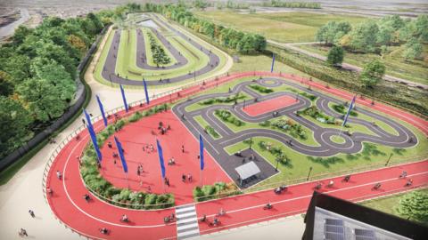 Artist impression of new hub, with cyclists going around two large red tracks. These are circling a cycle path in the centre, which is set up to look like a road layout. 