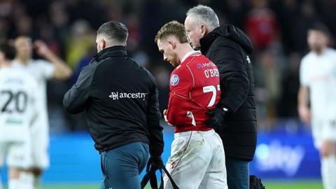 Lewis O'Brien is helped off