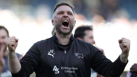 John Eustace celebrates by pumping his fists