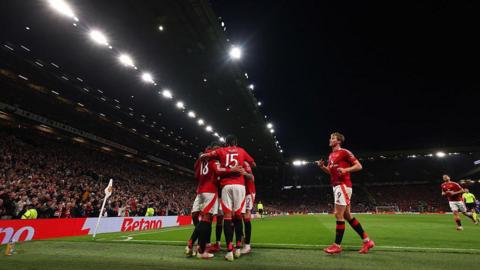 Manchester United players celebrate scoring 