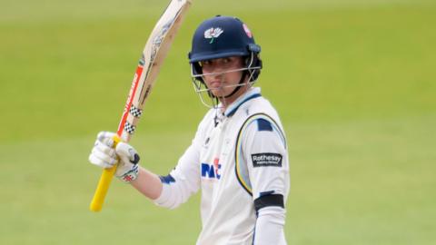 George Hill raises hit bat after reaching 50 for Yorkshire