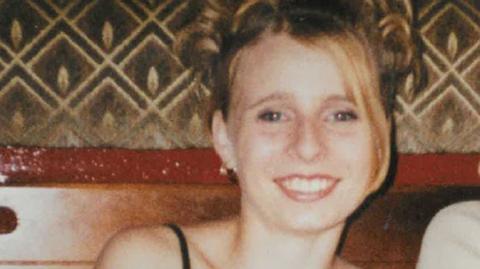 Victoria Hall, a young woman smiling to the camera. She has her blonde hair tied high on her head.