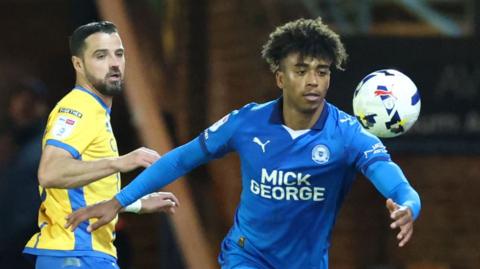 Peterborough United defender James Dornelly (right) in action against Mansfield Town