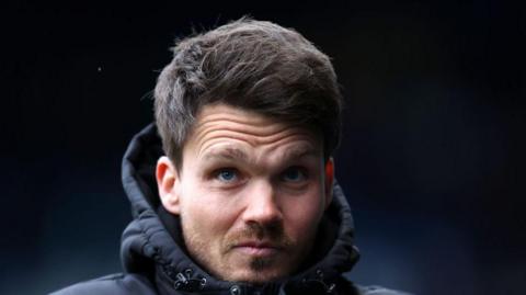 Danny Rohl looks up from the touchline as Sheffield Wednesday head coach.