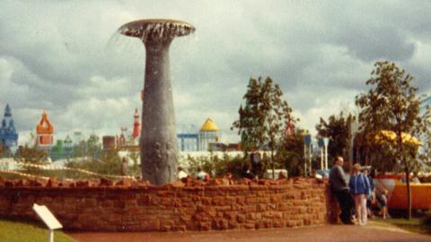 The Children of Glasgow fountain at the Garden Festival in 1988 - it is a large grey fountain surrounded by a red brick wall