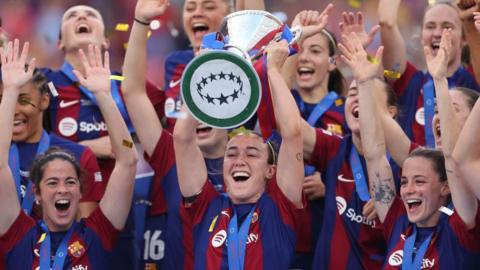 Lucy Bronze celebrates winning the Champions League