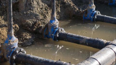 Three water mains with water running underneath