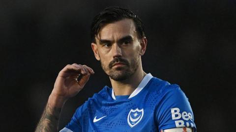 Marlon Pack, wearing the blue Portsmouth shirt, looks serious during a recent game